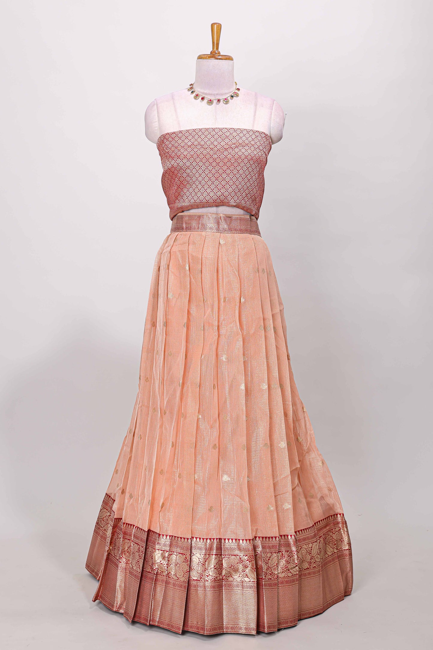 Orange kota cotton lehenga featuring a textured body with zari butta, finished with a contrast border and matching dhavani