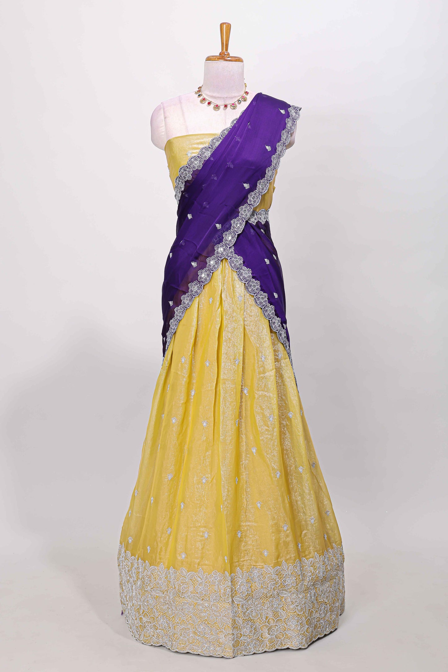 Yellow fendy chiffon lehenga with all over embroidery and stone work, paired with a contrast dhavani