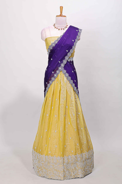 Yellow fendy chiffon lehenga with all over embroidery and stone work, paired with a contrast dhavani
