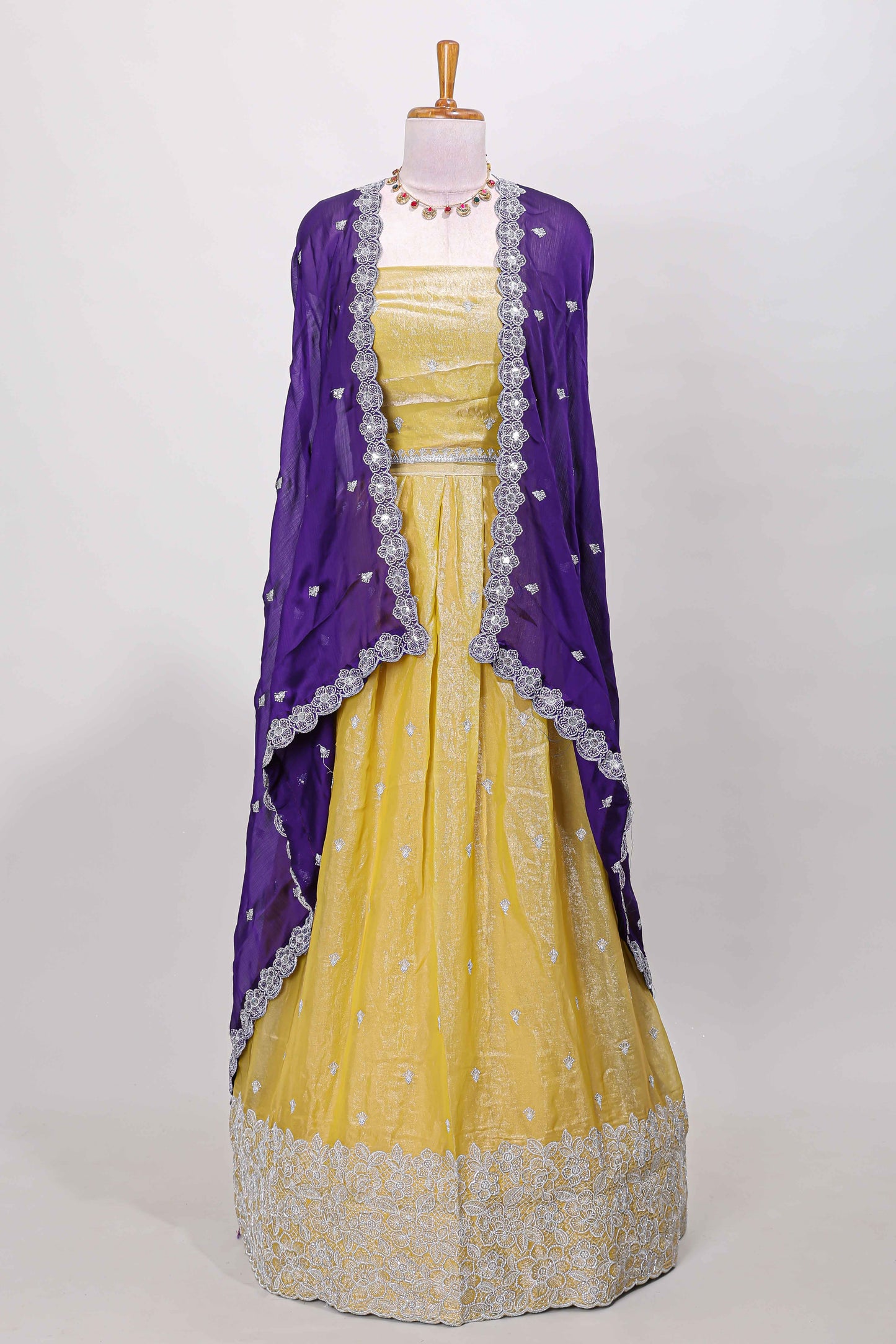 Yellow fendy chiffon lehenga with all over embroidery and stone work, paired with a contrast dhavani