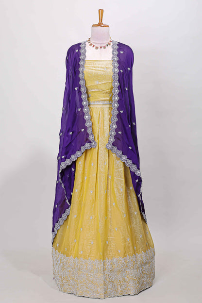 Yellow fendy chiffon lehenga with all over embroidery and stone work, paired with a contrast dhavani