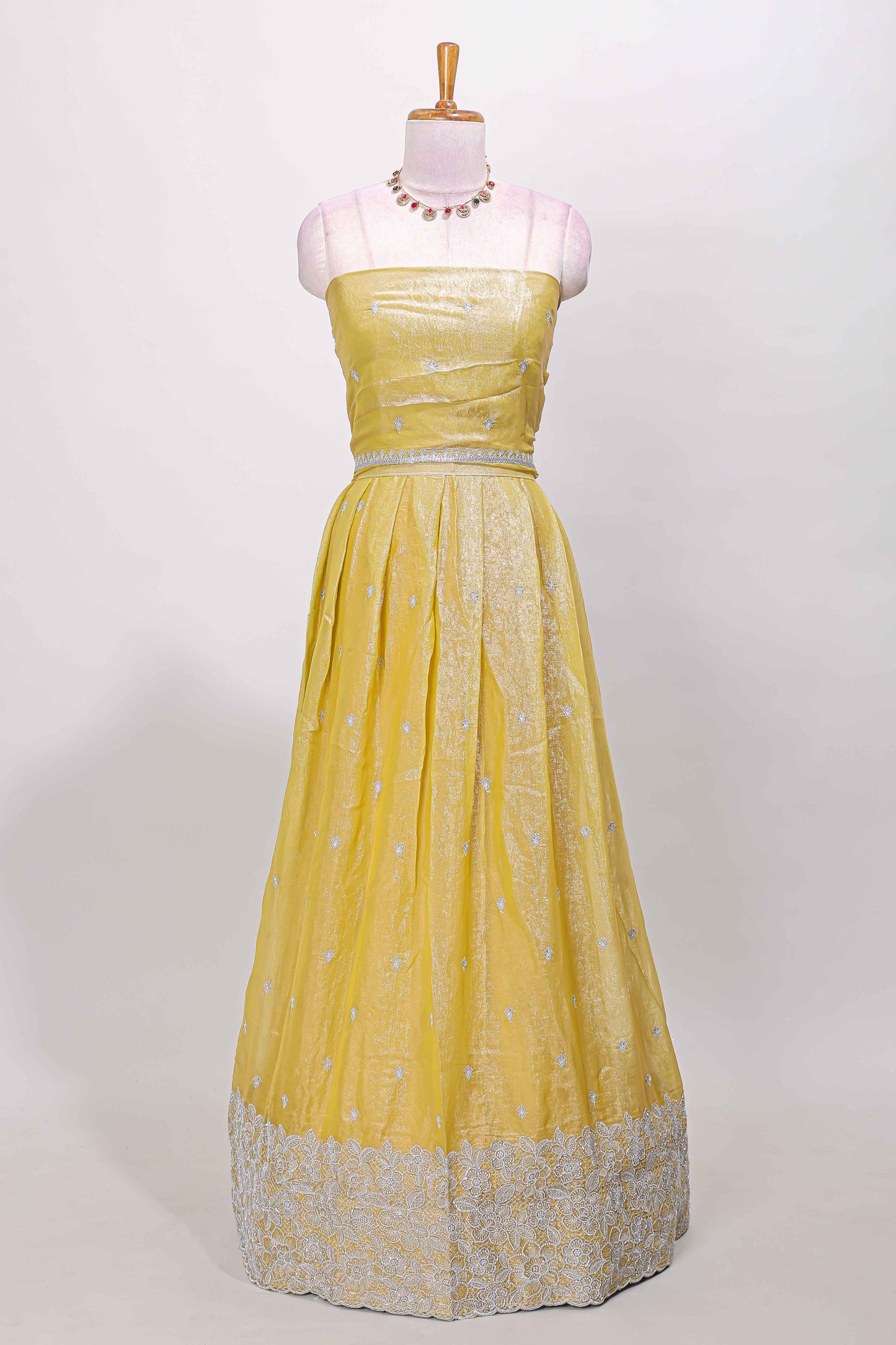 Yellow fendy chiffon lehenga with all over embroidery and stone work, paired with a contrast dhavani