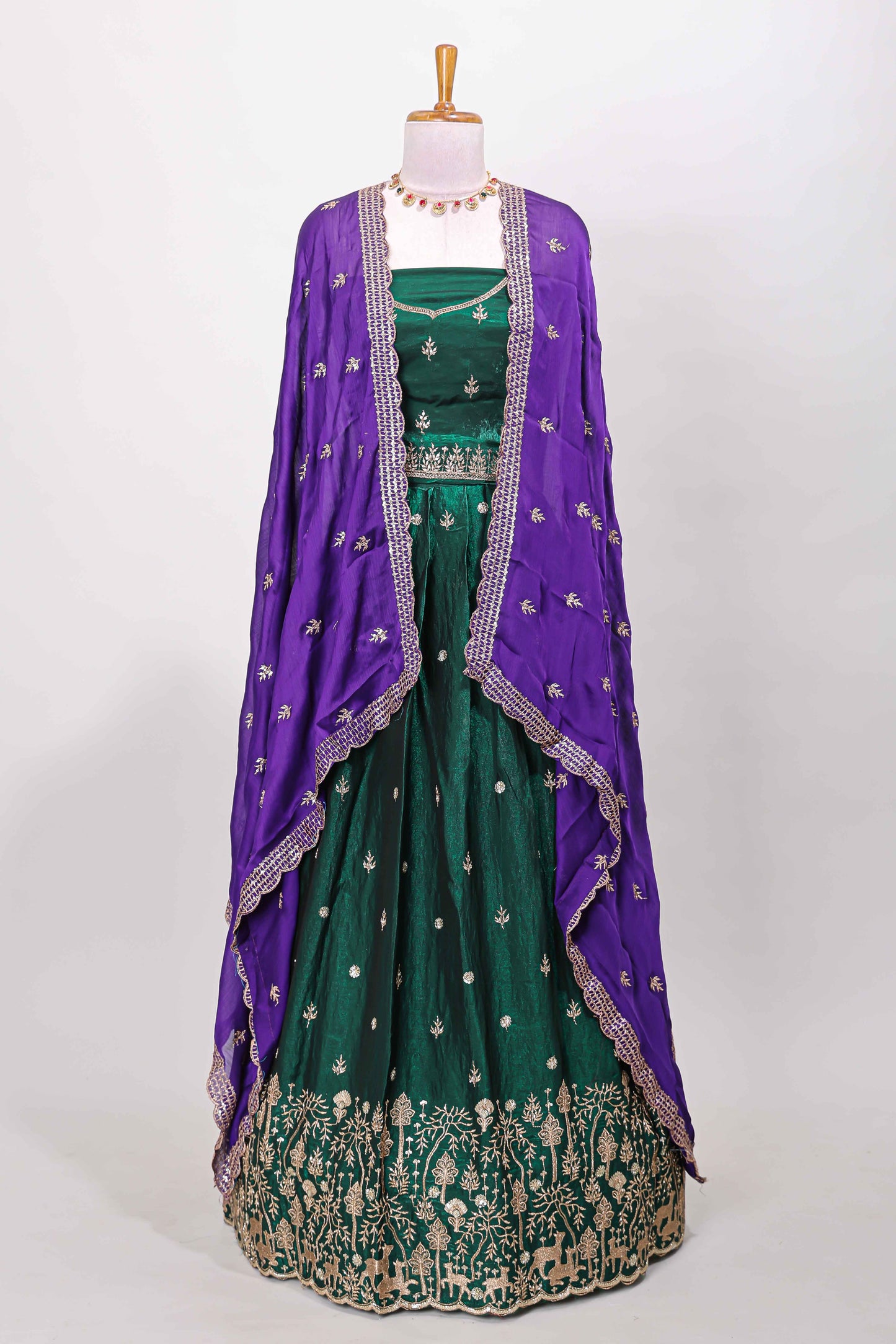 Green fendy chiffon lehenga with all over embroidery and stone work, paired with a contrast dhavani