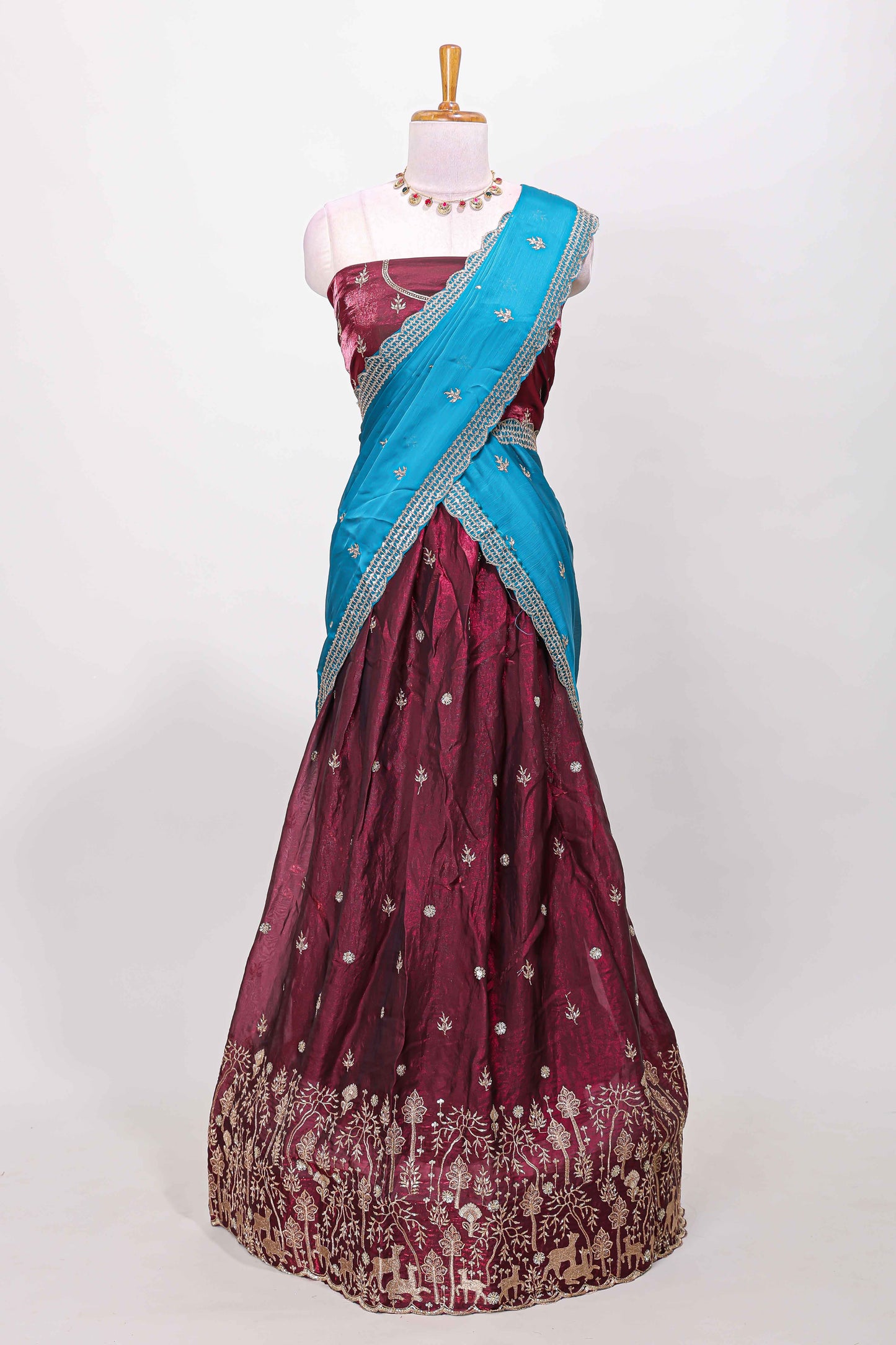 Maroon fendy chiffon lehenga with all over embroidery and stone work, paired with a contrast dhavani