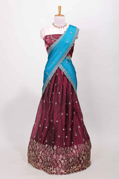 Maroon fendy chiffon lehenga with all over embroidery and stone work, paired with a contrast dhavani