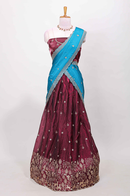 Maroon fendy chiffon lehenga with all over embroidery and stone work, paired with a contrast dhavani
