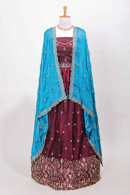 Maroon fendy chiffon lehenga with all over embroidery and stone work, paired with a contrast dhavani