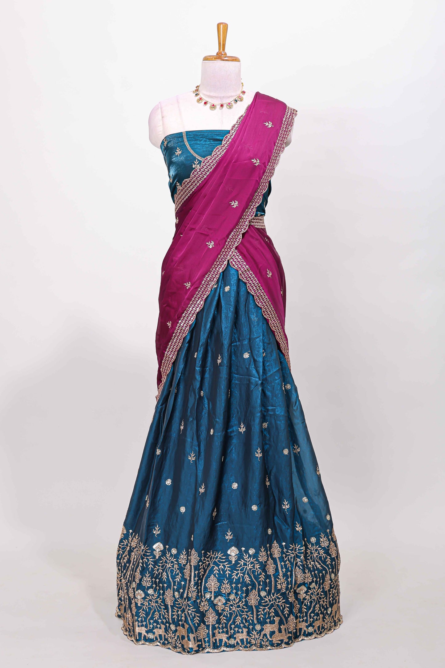 Peacock blue fendy chiffon lehenga with all over embroidery and stone work, paired with a contrast dhavani