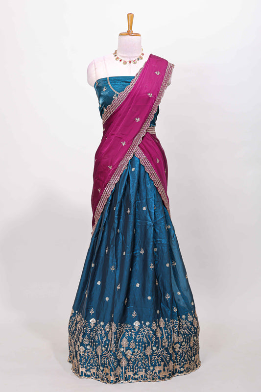 Peacock blue fendy chiffon lehenga with all over embroidery and stone work, paired with a contrast dhavani