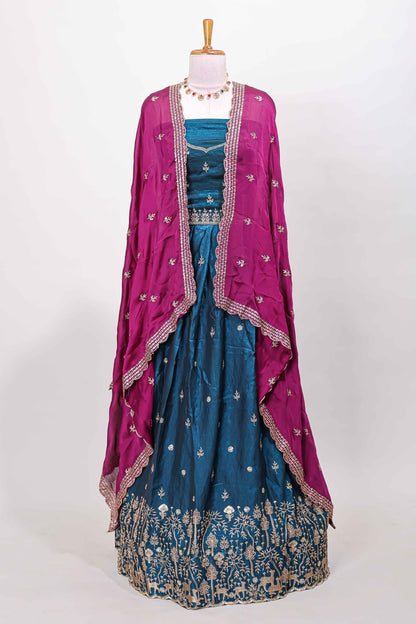 Peacock blue fendy chiffon lehenga with all over embroidery and stone work, paired with a contrast dhavani