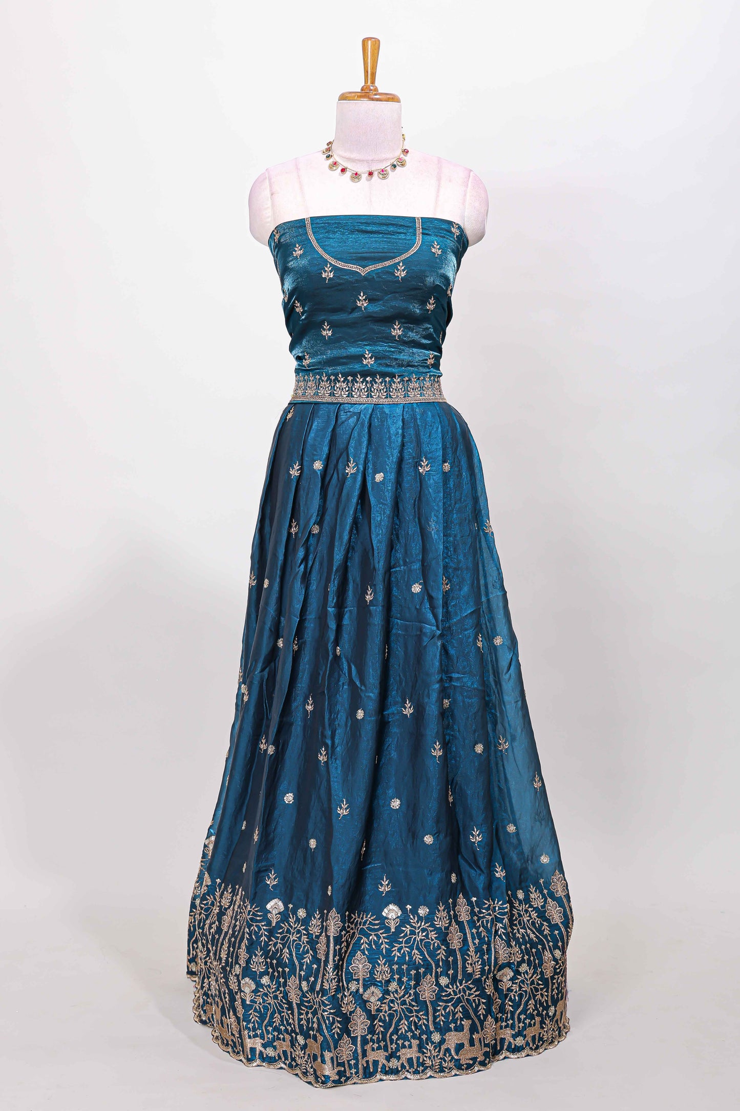 Peacock blue fendy chiffon lehenga with all over embroidery and stone work, paired with a contrast dhavani