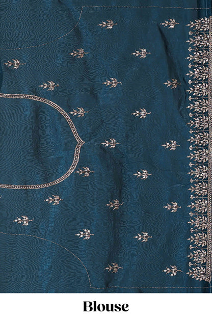 Peacock blue fendy chiffon lehenga with all over embroidery and stone work, paired with a contrast dhavani