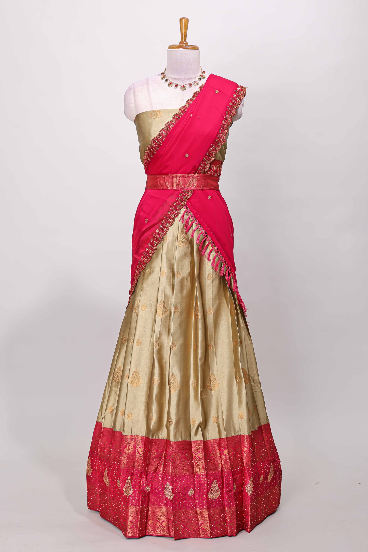 Golden raw silk zari butta lehenga with pink contrast border and dhavani