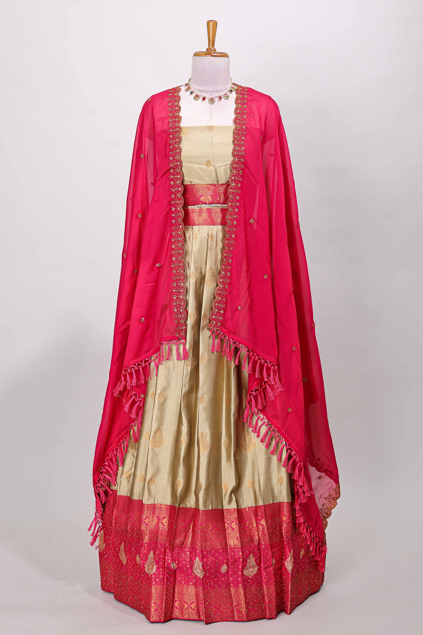Golden raw silk zari butta lehenga with pink contrast border and dhavani