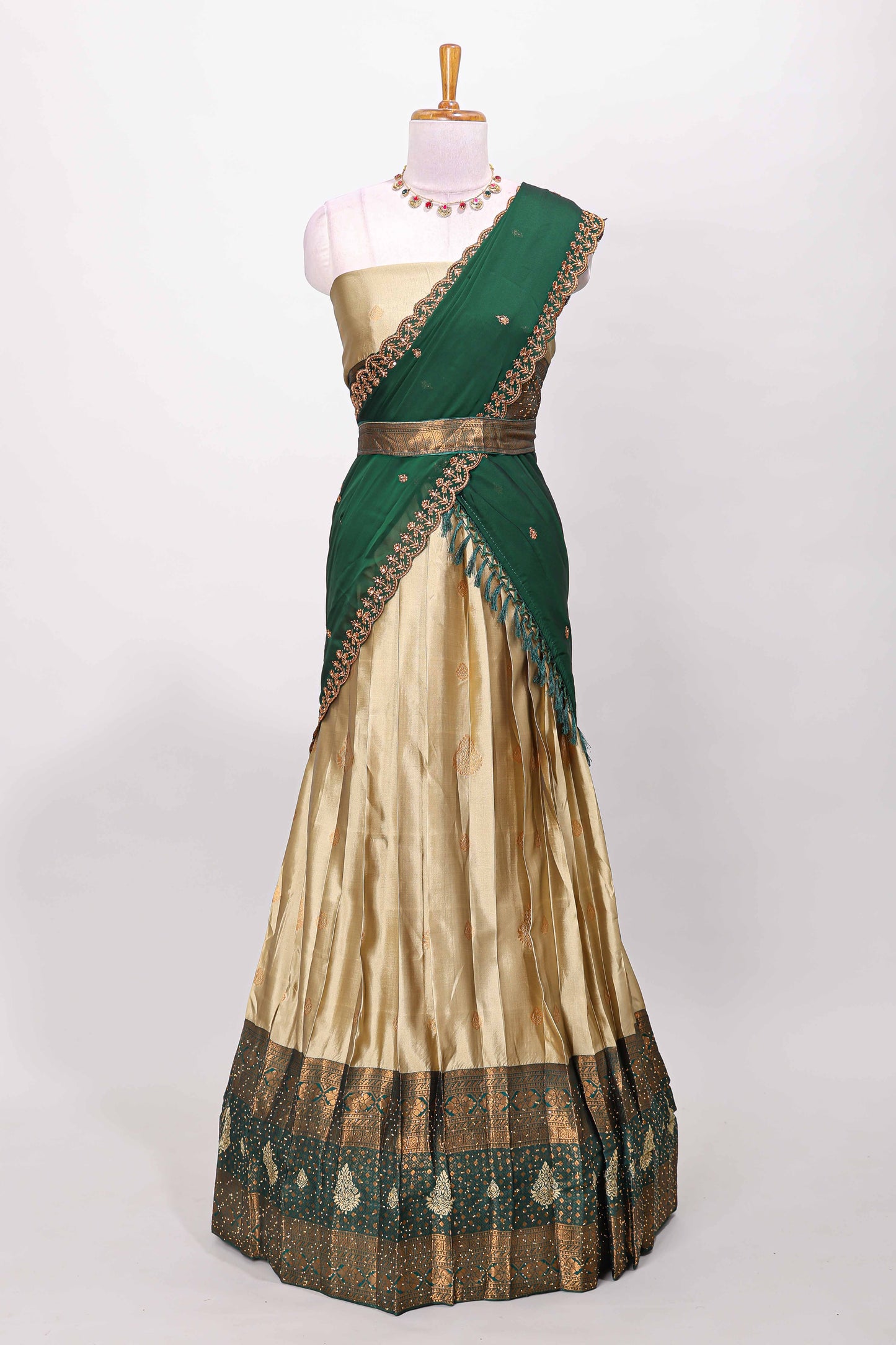 Golden raw silk zari butta lehenga with green contrast border and dhavani