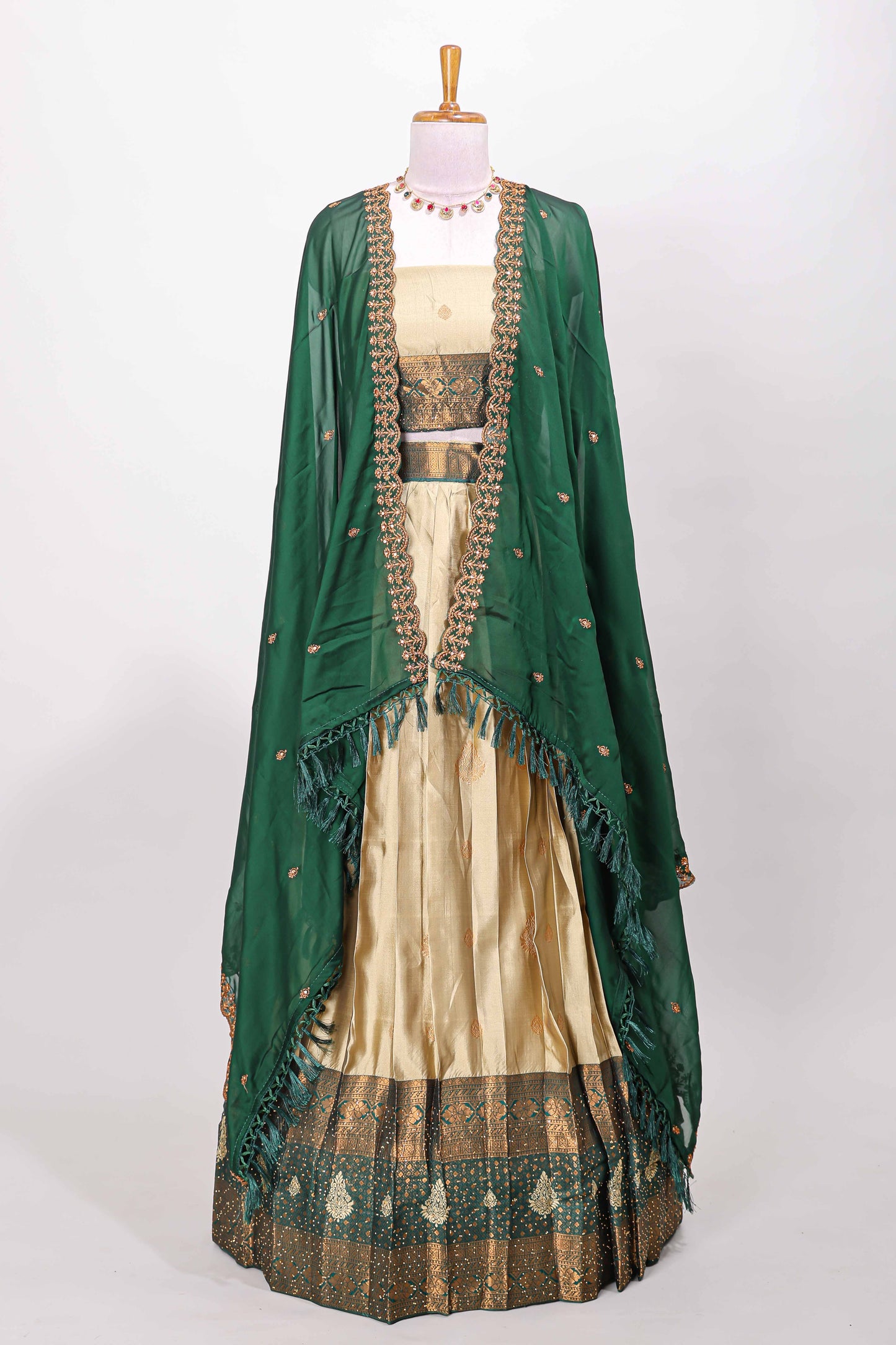 Golden raw silk zari butta lehenga with green contrast border and dhavani