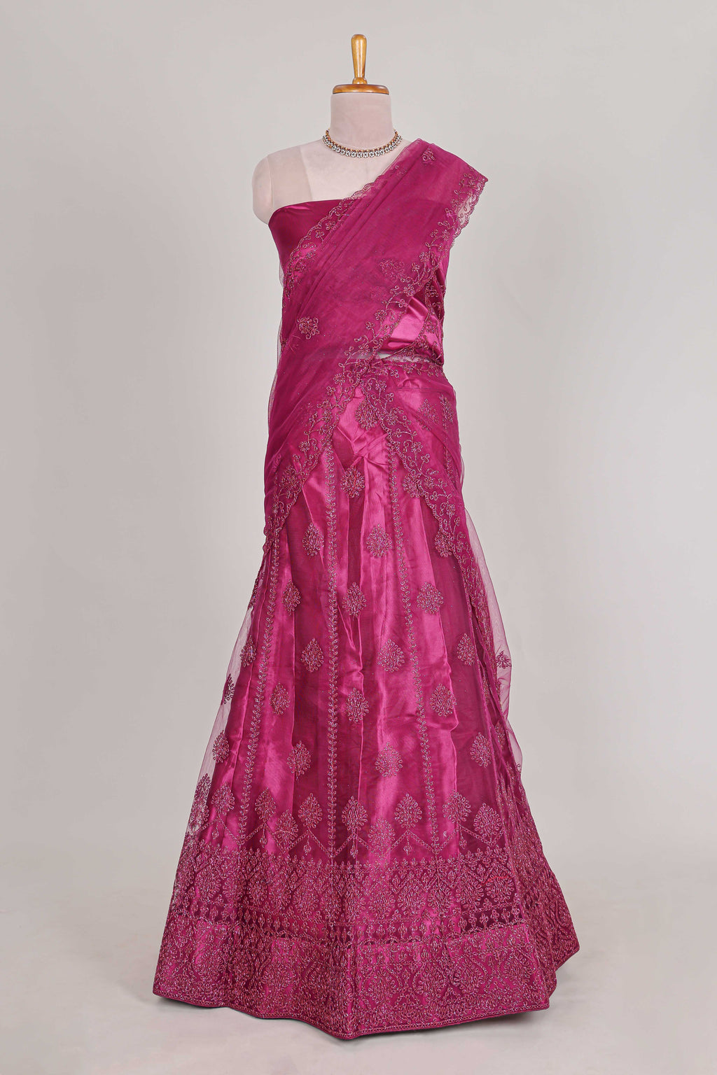 Rose colour net lehenga featuring delicate embroidery with a borderless design paired with a matching self shawl