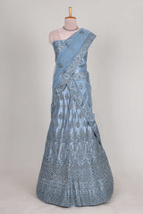 Sea blue colour net lehenga featuring delicate embroidery stone work with a borderless design paired with a matching self shawl