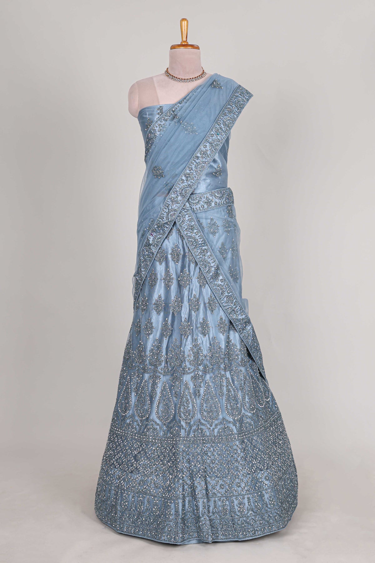 Sea blue colour net lehenga featuring delicate embroidery stone work with a borderless design paired with a matching self shawl