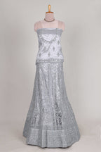 Silver colour net lehenga featuring delicate embroidery stone work with a borderless design paired with a matching self shawl