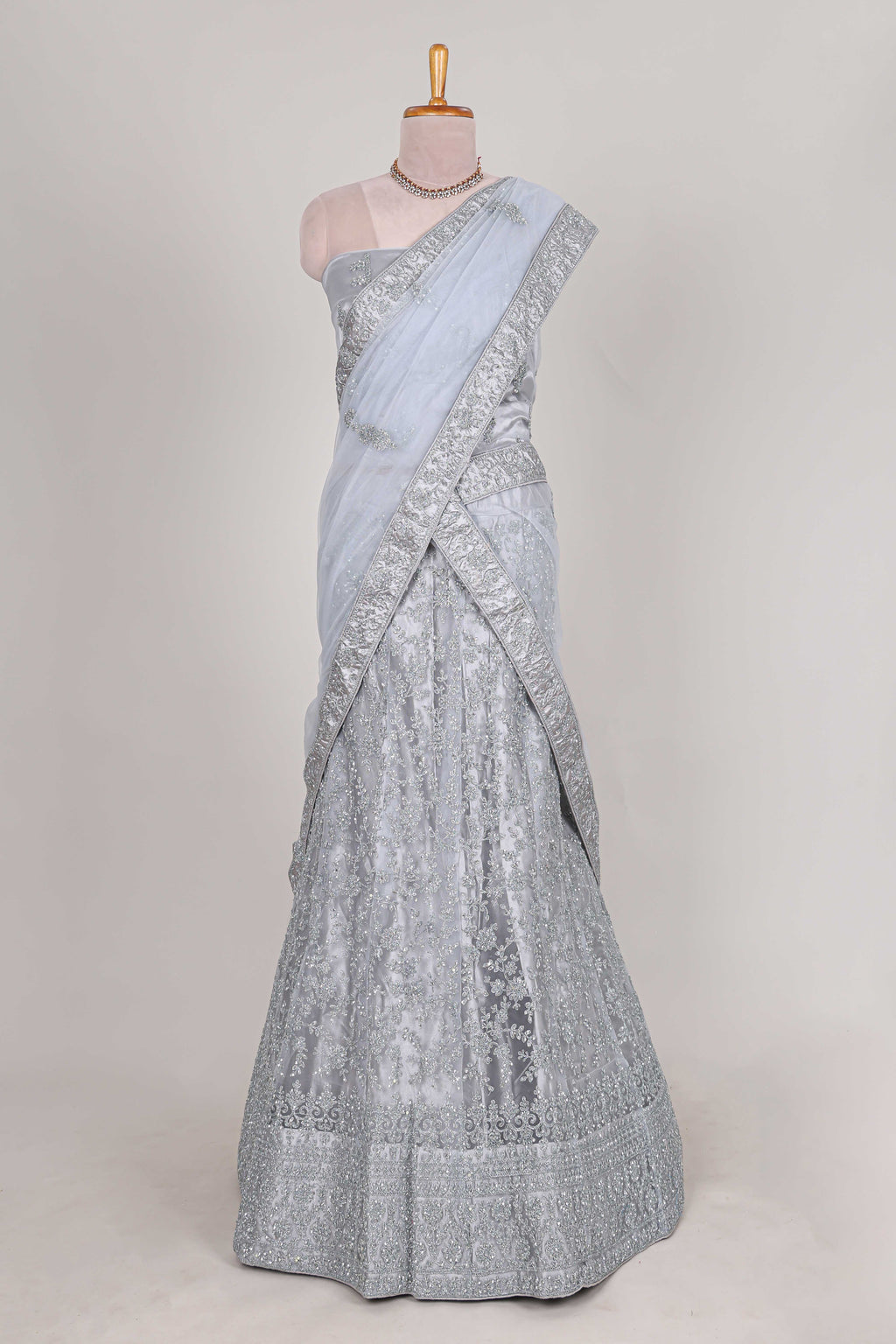 Silver colour net lehenga featuring delicate embroidery stone work with a borderless design paired with a matching self shawl