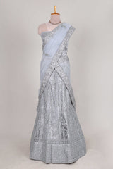 Silver colour net lehenga featuring delicate embroidery stone work with a borderless design paired with a matching self shawl
