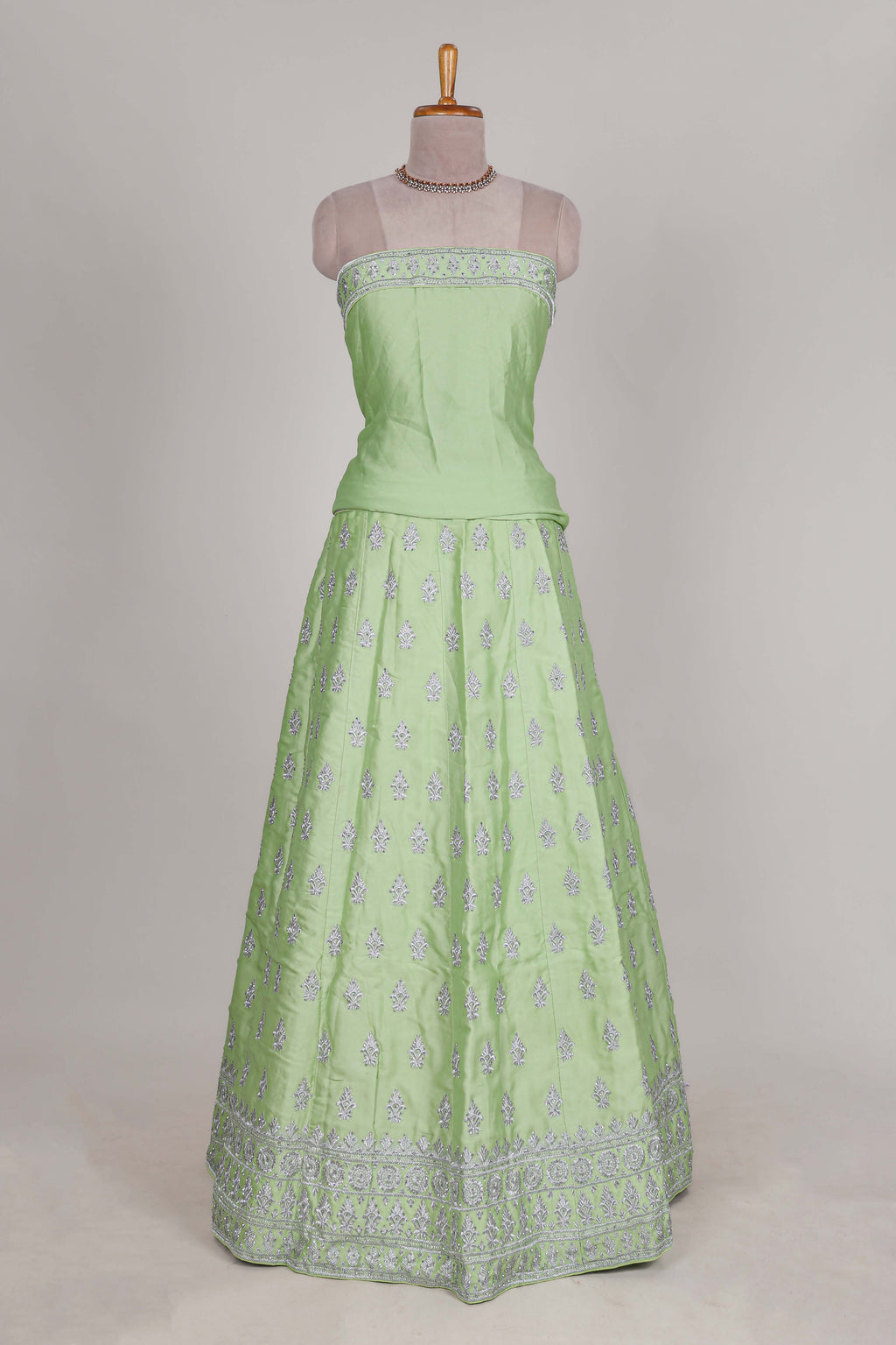 Powder green satin lehenga featuring delicate embroidery with a bordered design paired with a matching self shawl