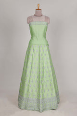 Powder green satin lehenga featuring delicate embroidery with a bordered design paired with a matching self shawl