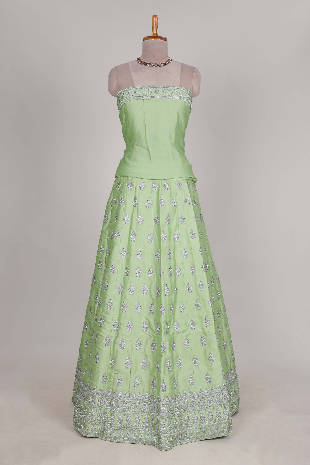 Powder green satin lehenga featuring delicate embroidery with a bordered design paired with a matching self shawl