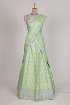 Powder green satin lehenga featuring delicate embroidery with a bordered design paired with a matching self shawl