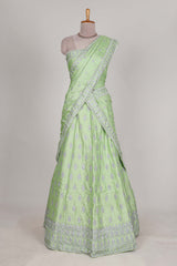 Powder green satin lehenga featuring delicate embroidery with a bordered design paired with a matching self shawl