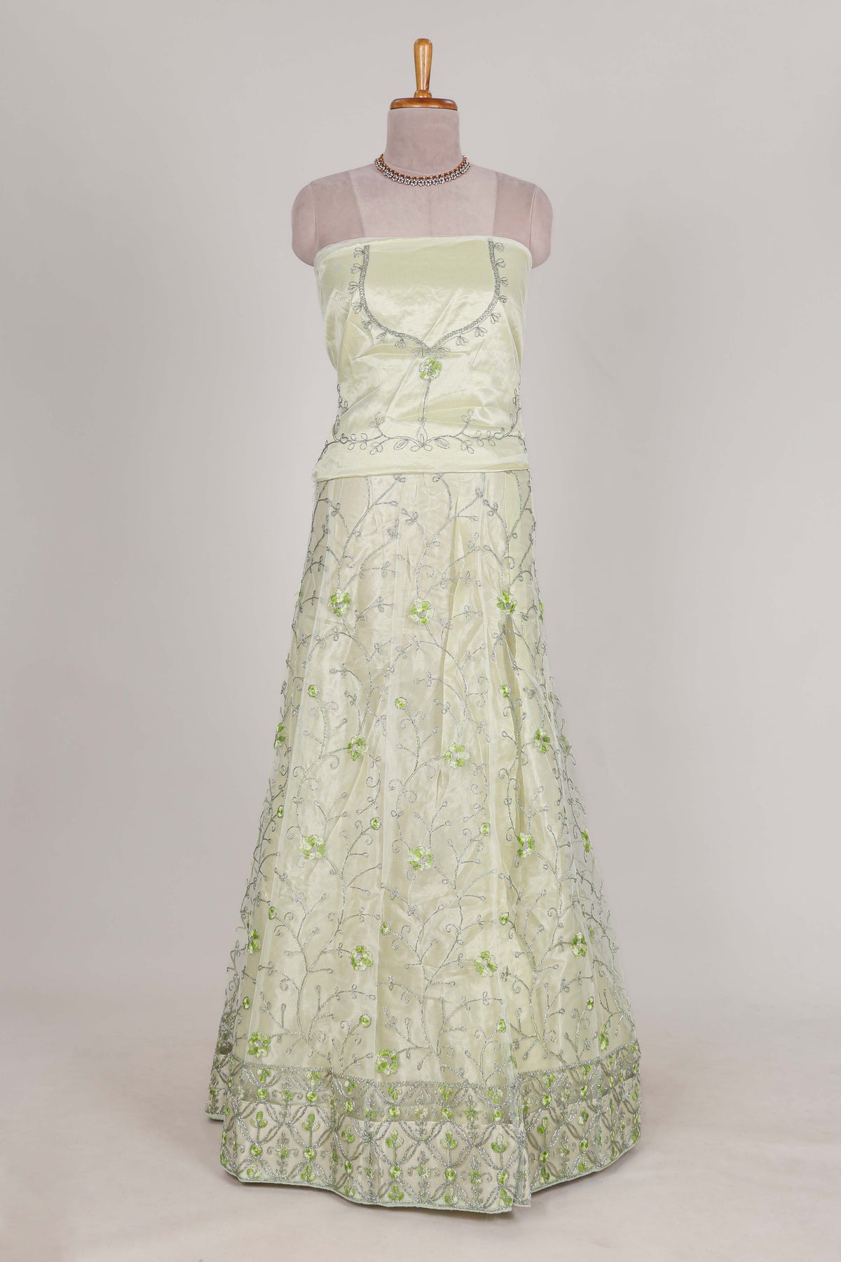 powder green net lehenga featuring delicate embroidery with a borderless design paired with a matching self shawl