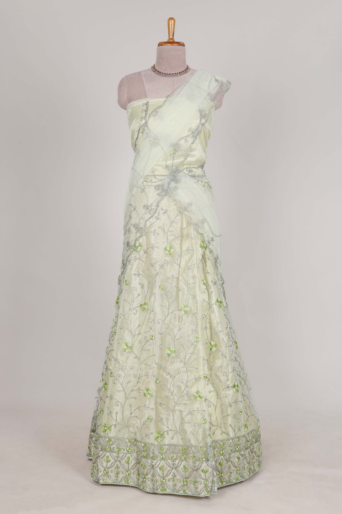 powder green net lehenga featuring delicate embroidery with a borderless design paired with a matching self shawl