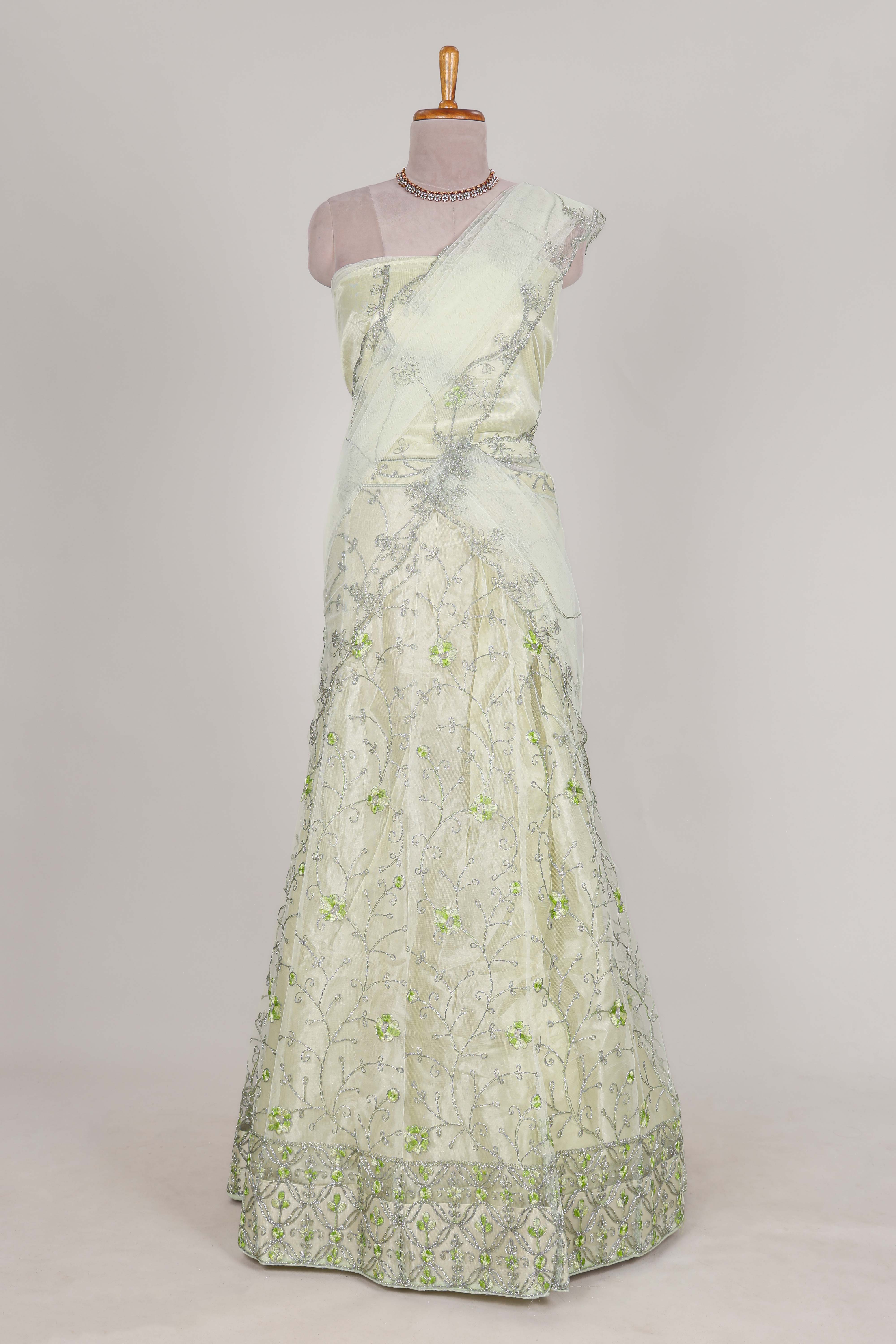 powder green net lehenga featuring delicate embroidery with a borderless design paired with a matching self shawl