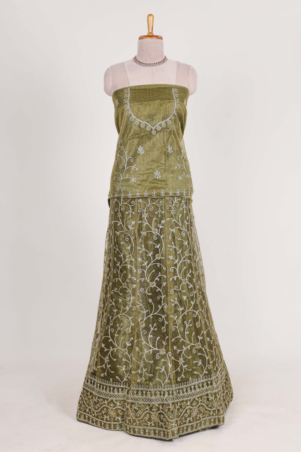 Olive Green net lehenga featuring delicate embroidery with a borderless design paired with a matching self shawl