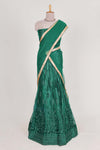 Bottle Green net lehenga featuring delicate embroidery with a borderless design paired with a matching self shawl