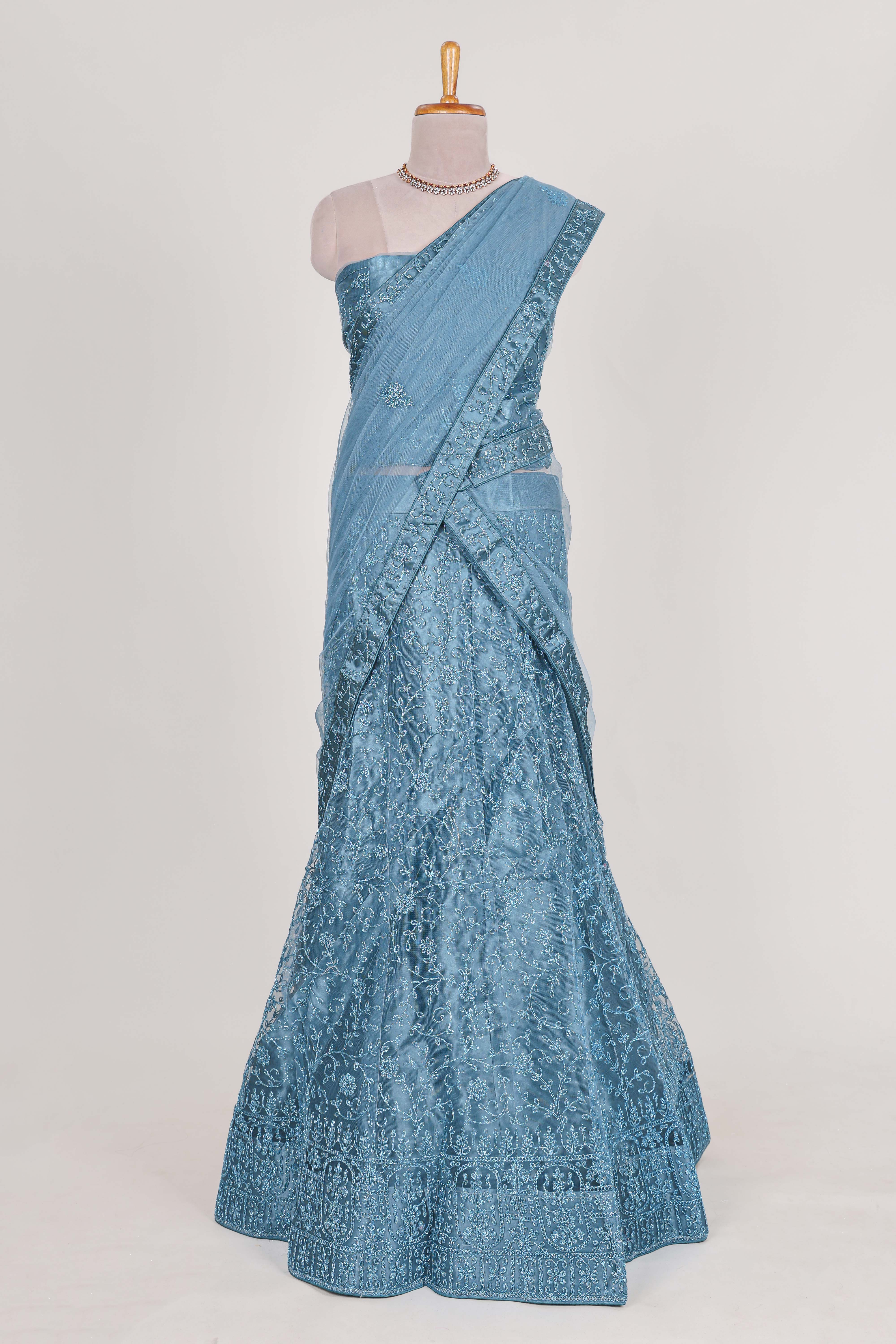 Blue colour net lehenga featuring delicate embroidery with a borderless design paired with a matching self shawl