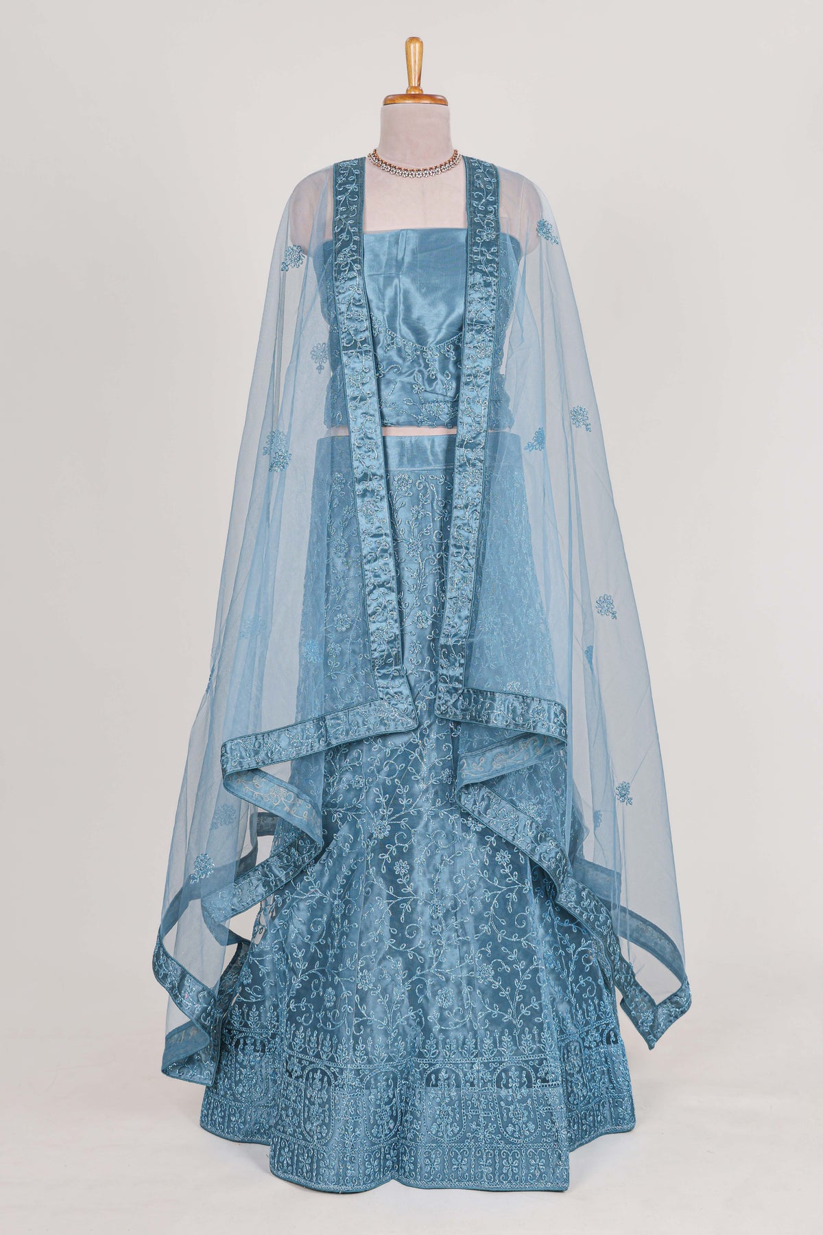 Blue colour net lehenga featuring delicate embroidery with a borderless design paired with a matching self shawl