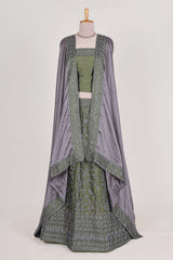 green satin lehenga featuring delicate embroidery with a bordered design paired with contrast shawl