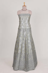 Silver satin lehenga featuring delicate embroidery with a bordered design paired with contrast shawl