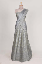 Silver satin lehenga featuring delicate embroidery with a bordered design paired with contrast shawl