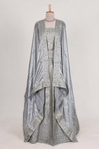 Silver satin lehenga featuring delicate embroidery with a bordered design paired with contrast shawl