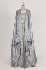 Silver satin lehenga featuring delicate embroidery with a bordered design paired with contrast shawl