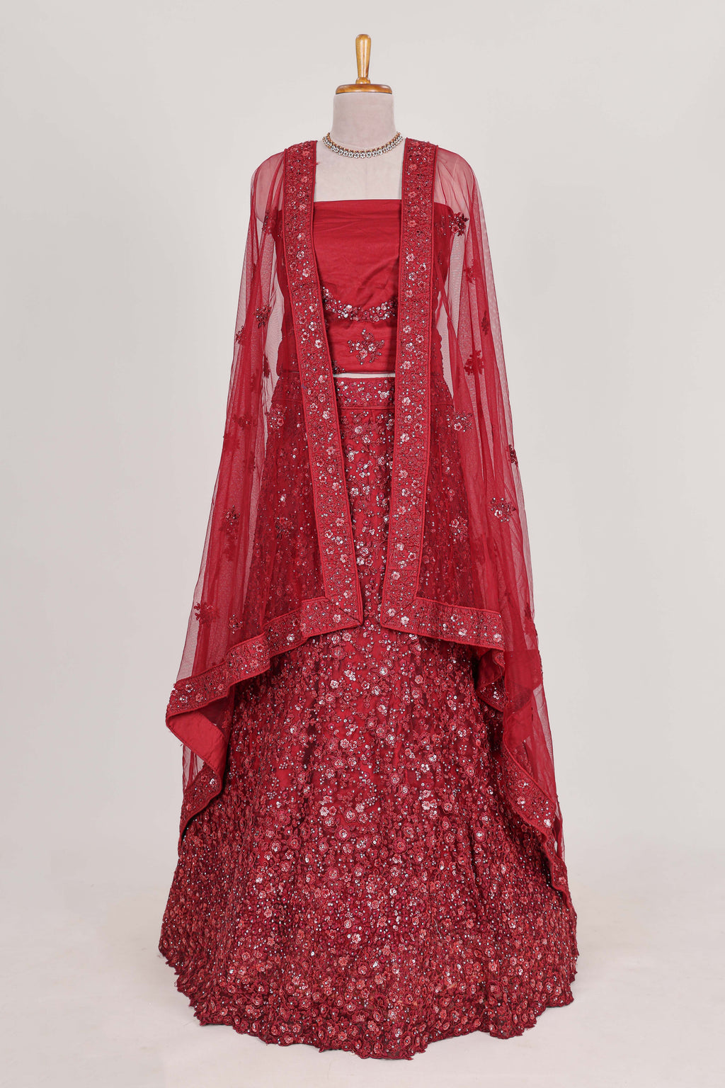 Beautiful net lehenga adorned with intricate embroidery Paired with a matching net shawl perfect for weddings and special occasions