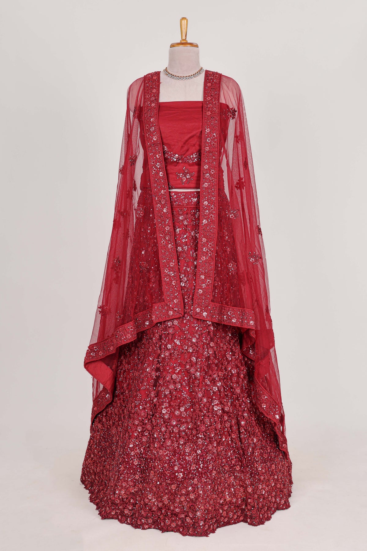 Beautiful net lehenga adorned with intricate embroidery Paired with a matching net shawl perfect for weddings and special occasions