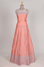 Peach satin lehenga featuring delicate embroidery with a bordered design paired with contrast shawl