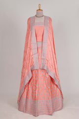 Peach satin lehenga featuring delicate embroidery with a bordered design paired with contrast shawl