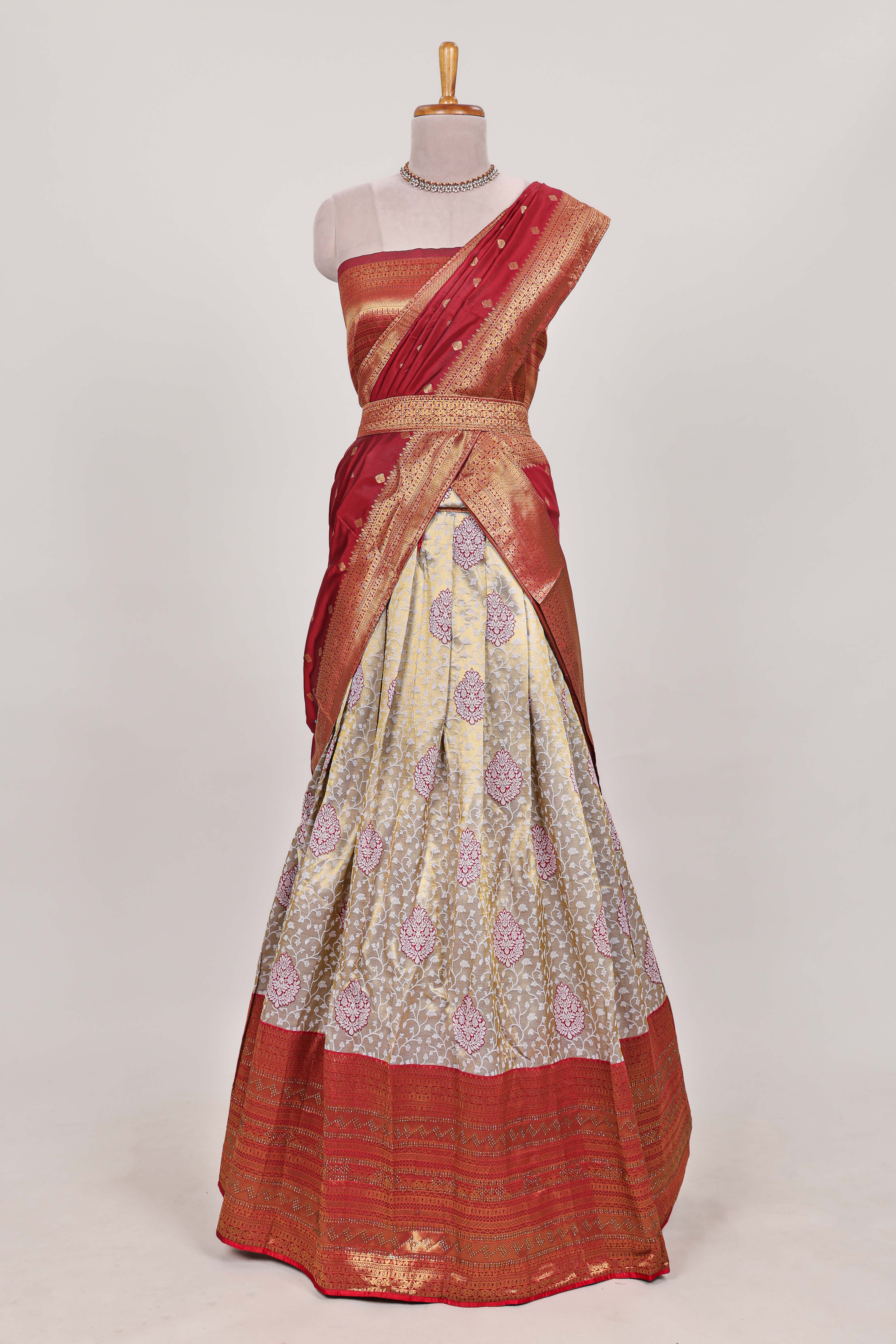 Red tissue lehenga featuring intricate thread weaving details with a beautiful contrast border Paired with a brocadeshawl
