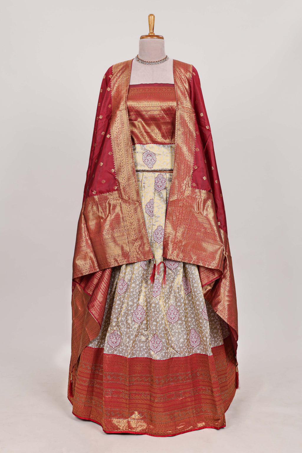 Red tissue lehenga featuring intricate thread weaving details with a beautiful contrast border Paired with a brocade  shawl