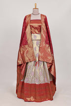 Red tissue lehenga featuring intricate thread weaving details with a beautiful contrast border Paired with a brocade  shawl